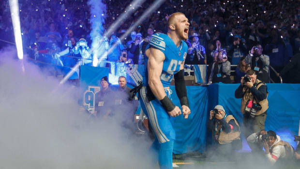 Detroit Lions defensive end Aidan Hutchinson runs out of the tunnel for player introductions before kickoff against the Tampa Bay Buccaneers in the NFC divisional round at Ford Field in Detroit on Sunday, Jan. 21, 2024.  